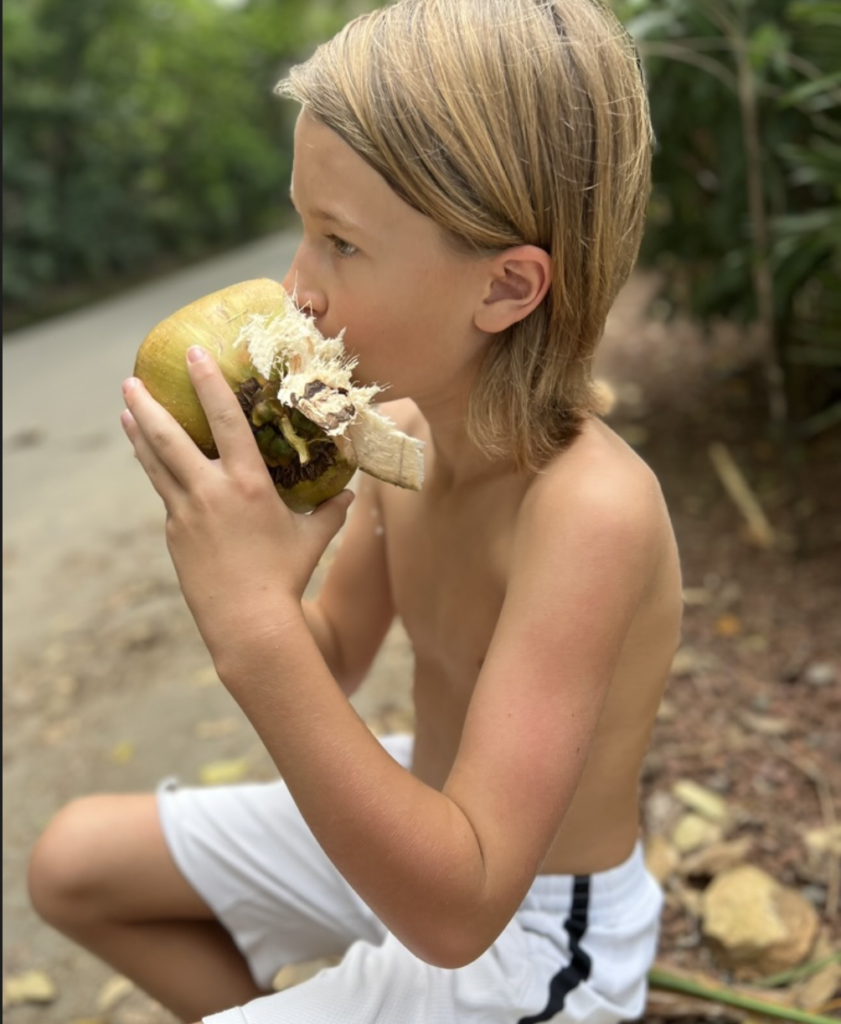 boy drinking from coconut